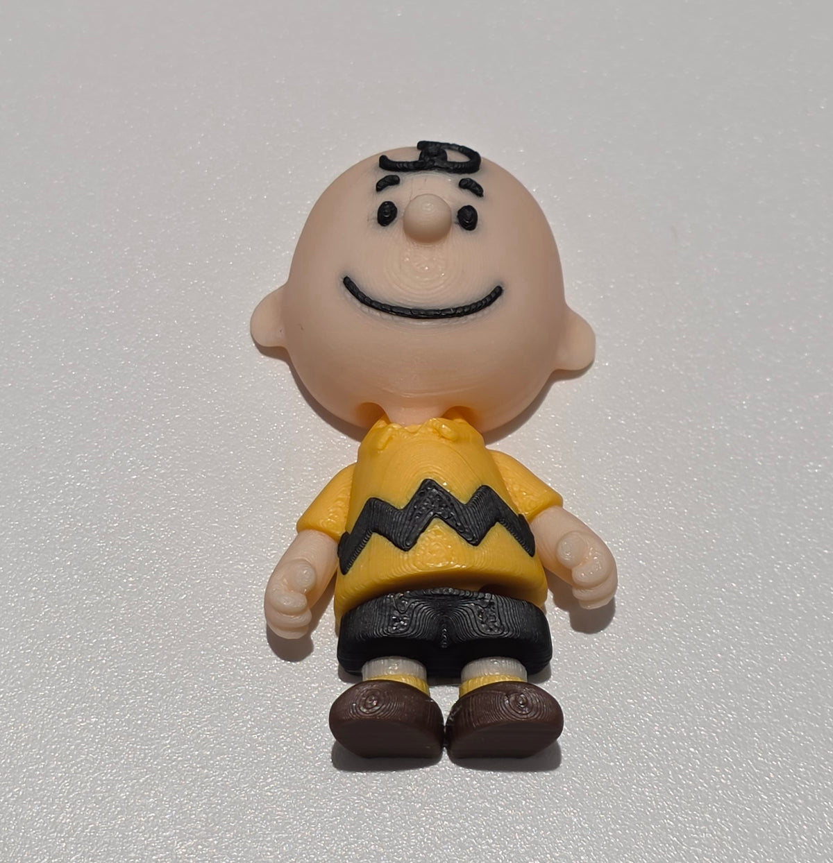 Articulated Charlie Brown Minifigure Collectible Keychain.
