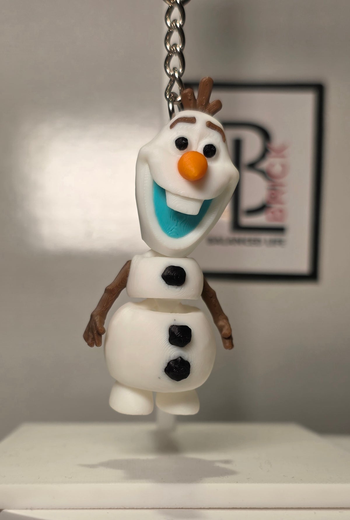 Articulated Olaf Bell Minifigure Collectible Keychain.